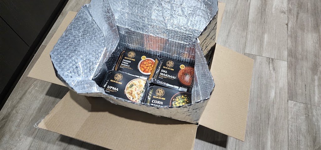 Packaged ready-made Indian meals from Jewel Of Asia in an insulated delivery box
