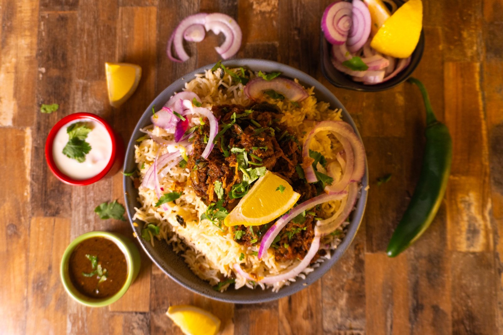 Pulao House biryani plate with raita and onions