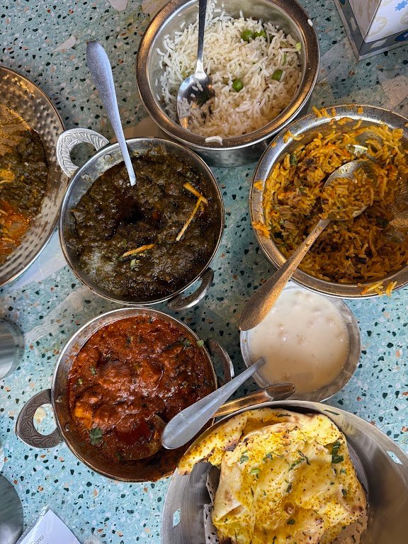 Mitran Da Dhaba biryani and curry spread