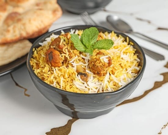 Lucknowi Bites biryani bowl with mint garnish