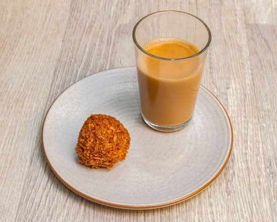 Chai Parantha Parramatta masala chai in a glass with a fried snack