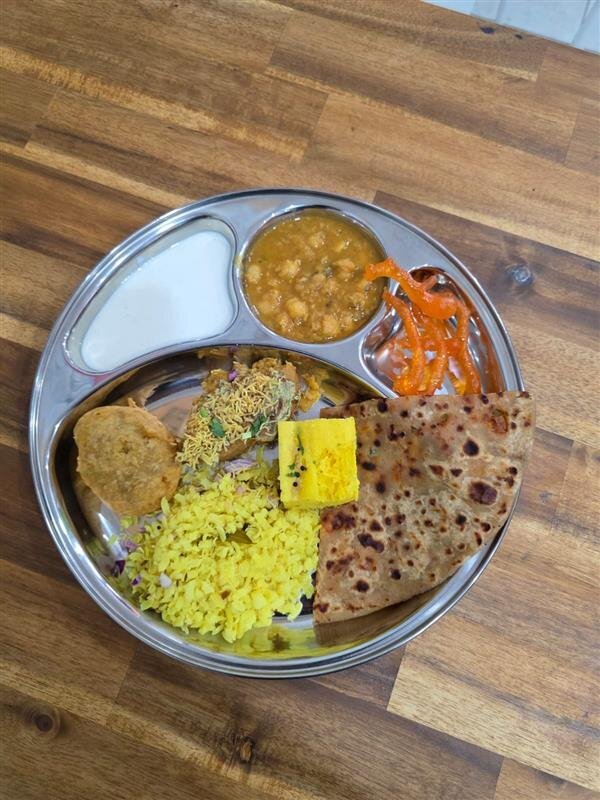Chai Nashta Pendle Hill thali plate with poha, paratha, dhokla, curd and pickle