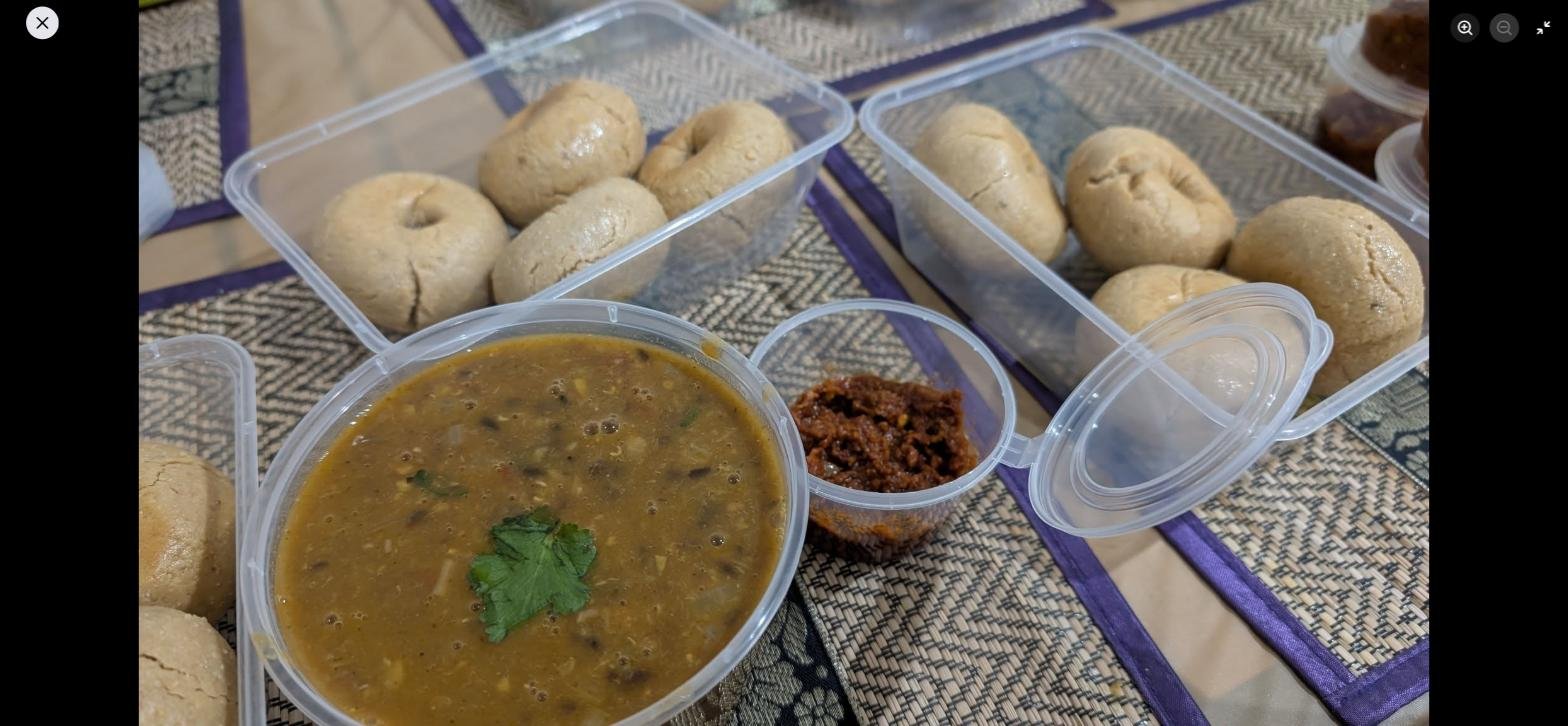 Desi Rasoi by Seema dal, baati and garlic chutney in takeaway containers