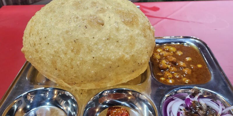 Dharma's Amritsari Dhaba chole bhature with a single large bhatura