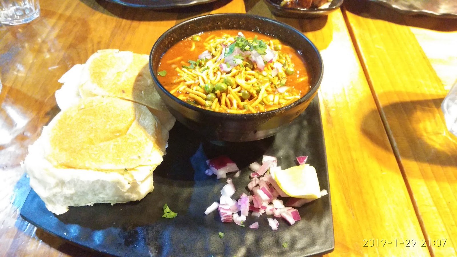 Chatkazz Harris Park Restaurant misal pav bowl with farsan onion and lemon on the side