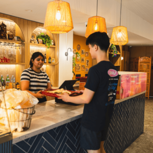 Naan Sense Indian Diner Newtown staff serving a young customer at the counter