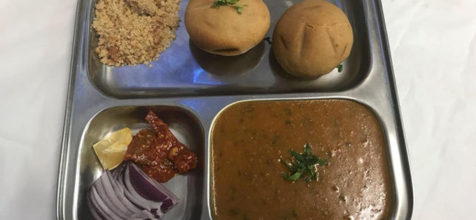 Savariya Quakers Hill Rajasthani thali with dal, bati, churma, chutney and onion