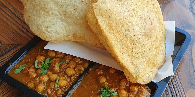 THALIKING chole bhature with fried bhature and onions