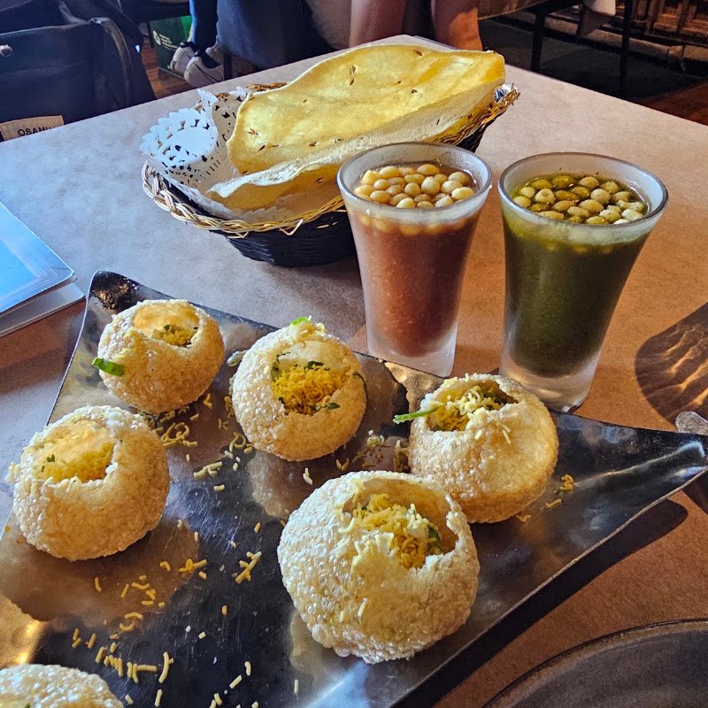 The Spice Room pani puri shots served in tall glasses with puris on the side